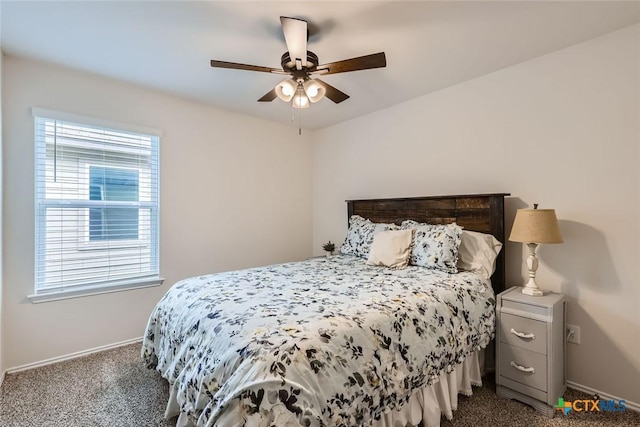 carpeted bedroom featuring multiple windows and ceiling fan