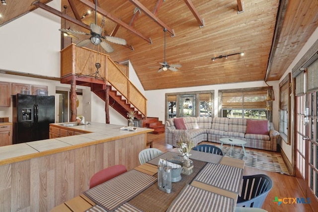 kitchen featuring sink, black fridge, wooden ceiling, tile counters, and light hardwood / wood-style floors