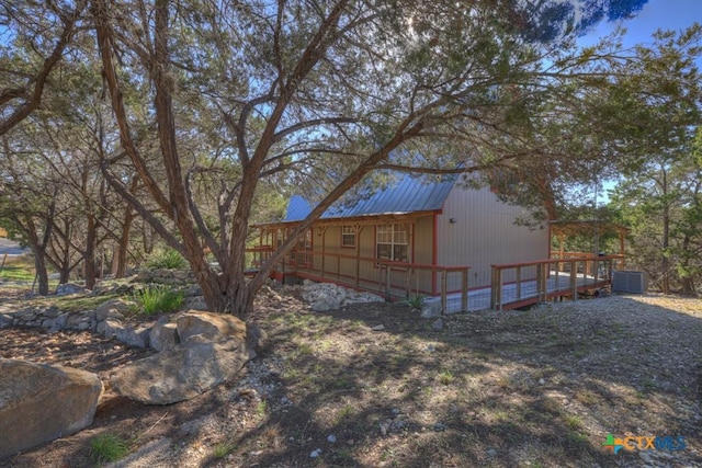 exterior space featuring a wooden deck and central AC