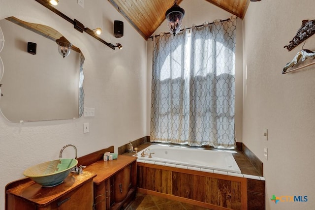 bathroom featuring tile patterned floors, a bathing tub, and vaulted ceiling