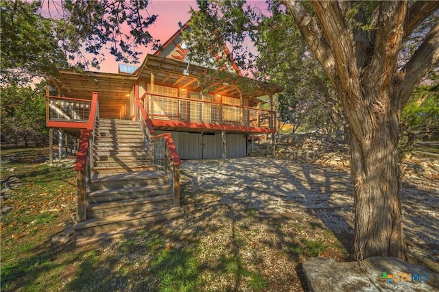 view of front facade with a wooden deck