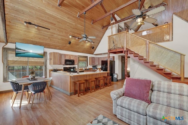 interior space featuring wood ceiling, ceiling fan, and light wood-type flooring