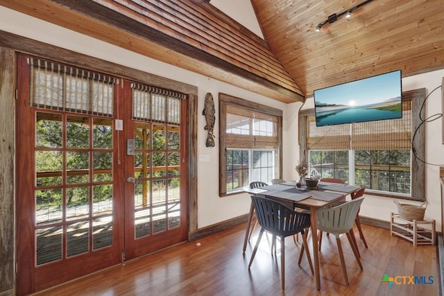 sunroom with vaulted ceiling, rail lighting, and french doors