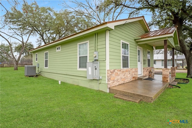 view of home's exterior with a yard, a patio, and cooling unit