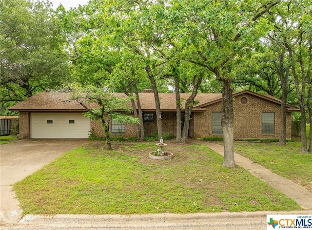 ranch-style house featuring a garage and a front lawn