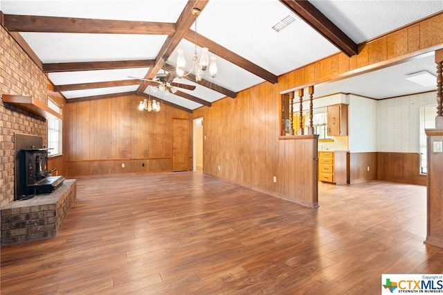 unfurnished living room featuring hardwood / wood-style flooring, lofted ceiling with beams, and a wealth of natural light