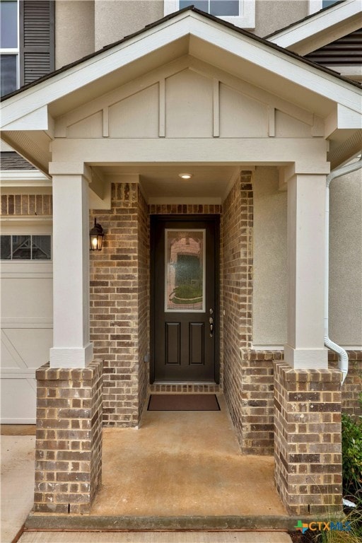 view of exterior entry with a garage