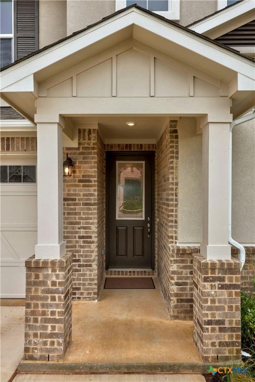 124 Jasmine Ln, Marble Falls, TX 78654 - doorway to property featuring brick siding and a garage