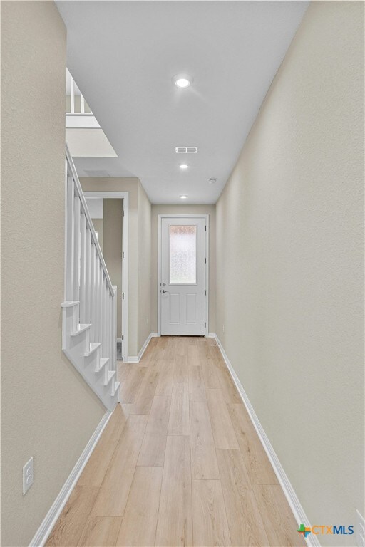 124 Jasmine Ln, Marble Falls, TX 78654 - doorway to outside with light wood finished floors, baseboards, stairs, and recessed lighting