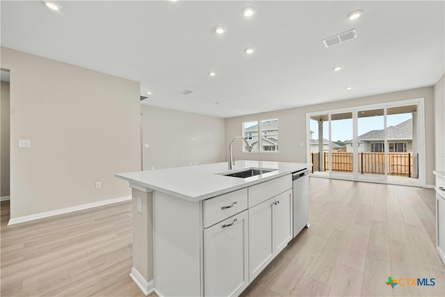 124 Jasmine Ln, Marble Falls, TX 78654 - kitchen with a sink, stainless steel dishwasher, light wood-style flooring, light countertops, and recessed lighting