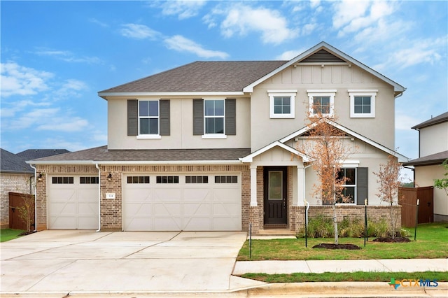 124 Jasmine Ln, Marble Falls, TX 78654 - view of front of house featuring brick siding, driveway, roof with shingles, a garage, and board and batten siding