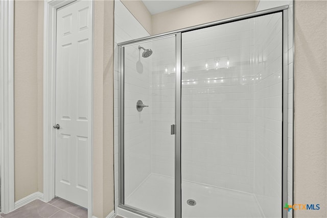 124 Jasmine Ln, Marble Falls, TX 78654 - bathroom featuring a stall shower, tile patterned floors, and baseboards