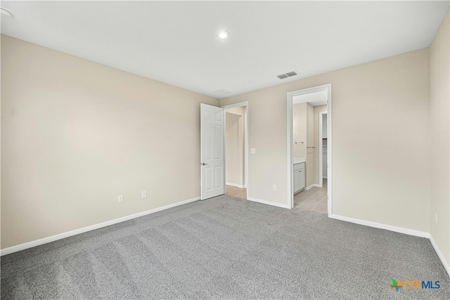124 Jasmine Ln, Marble Falls, TX 78654 - unfurnished bedroom with light carpet, baseboards, recessed lighting, and ensuite bathroom