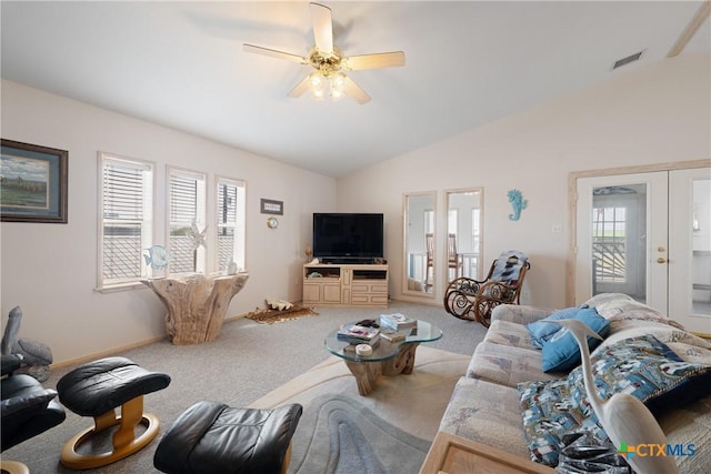 carpeted living room with lofted ceiling, ceiling fan, and french doors