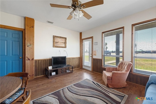 living room featuring hardwood / wood-style flooring and ceiling fan