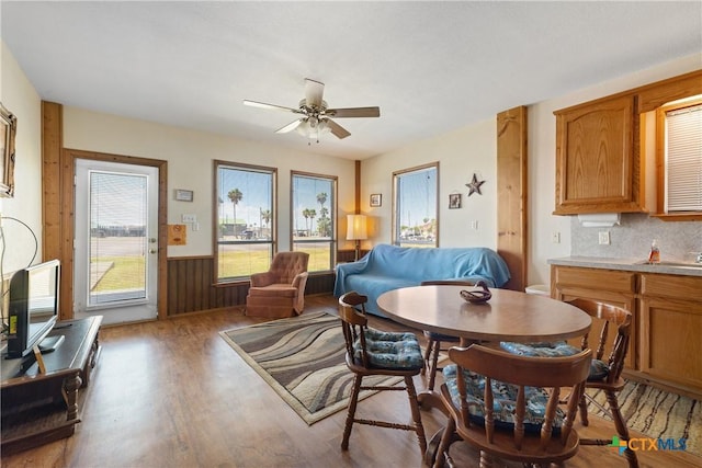 dining space with hardwood / wood-style flooring and ceiling fan