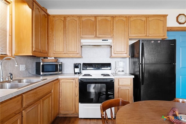 kitchen featuring sink, tasteful backsplash, electric range oven, black refrigerator, and light hardwood / wood-style floors