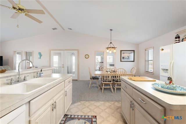 kitchen featuring pendant lighting, plenty of natural light, sink, and light carpet