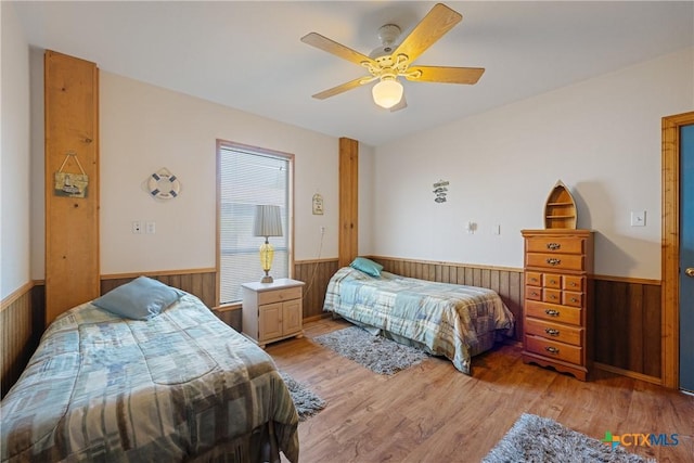 bedroom with ceiling fan and light hardwood / wood-style flooring