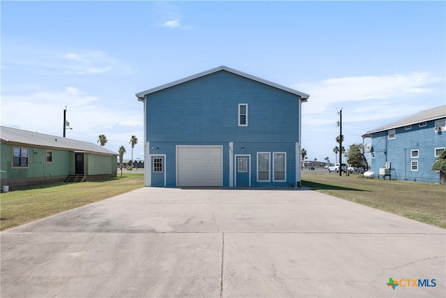 view of side of home with a garage and a lawn