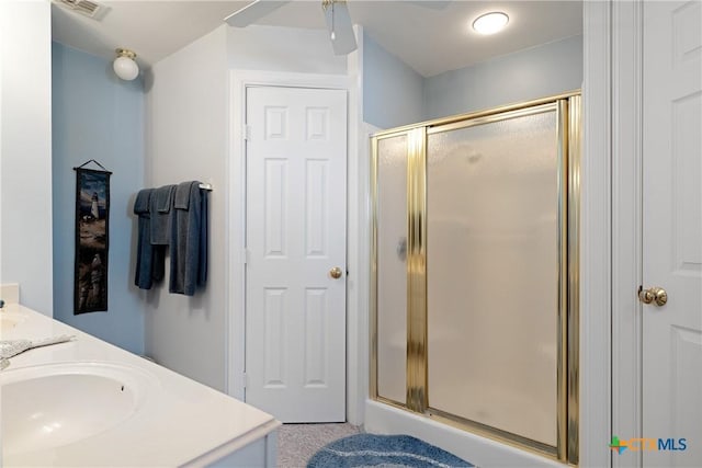 bathroom with vanity and a shower with shower door