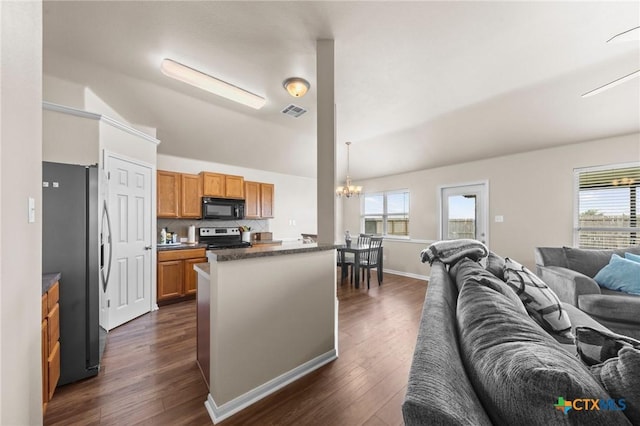 7831 Redbrush, Temple, TX 76502 - kitchen featuring stainless steel appliances, open floor plan, a chandelier, dark countertops, and lofted ceiling