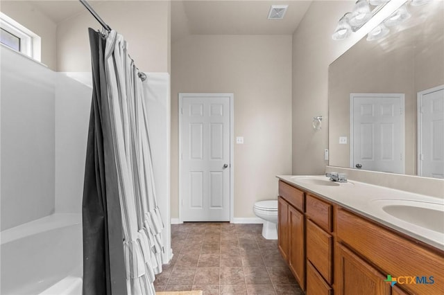 7831 Redbrush, Temple, TX 76502 - bathroom featuring double vanity, shower / tub combo with curtain, toilet, and baseboards