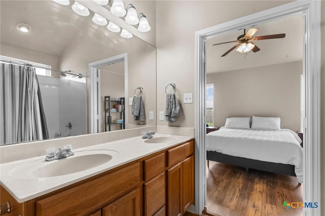 7831 Redbrush, Temple, TX 76502 - ensuite bathroom with double vanity, a ceiling fan, wood finished floors, and a shower with shower curtain