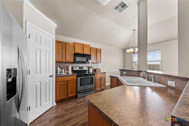 7831 Redbrush, Temple, TX 76502 - kitchen with stainless steel appliances, a sink, tasteful backsplash, brown cabinetry, and lofted ceiling