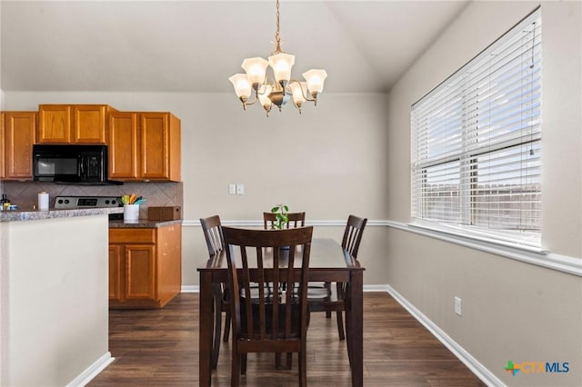 7831 Redbrush, Temple, TX 76502 - dining area featuring a chandelier, dark wood-style flooring, lofted ceiling, and baseboards