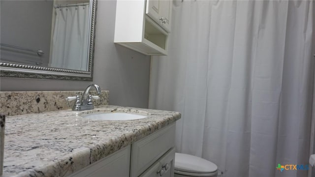 bathroom featuring toilet and vanity