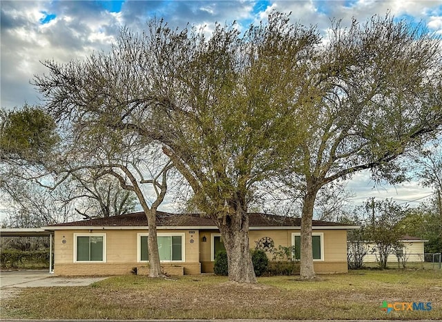 single story home with a front lawn and an attached carport