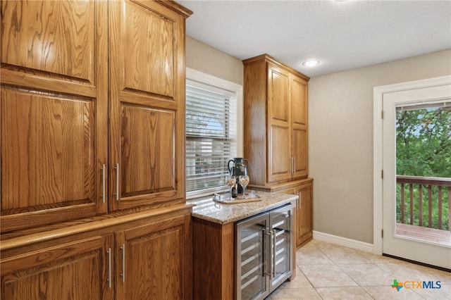 95 Mission Dr, New Braunfels, TX 78130 - bar with wine cooler, baseboards, a healthy amount of sunlight, and light tile patterned floors