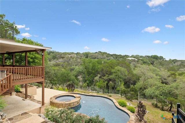 95 Mission Dr, New Braunfels, TX 78130 - view of pool with a pool with connected hot tub, a wooded view, fence, and a patio area