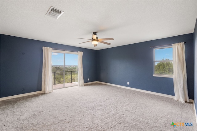 95 Mission Dr, New Braunfels, TX 78130 - carpeted empty room with baseboards, ceiling fan, visible vents, and a textured ceiling