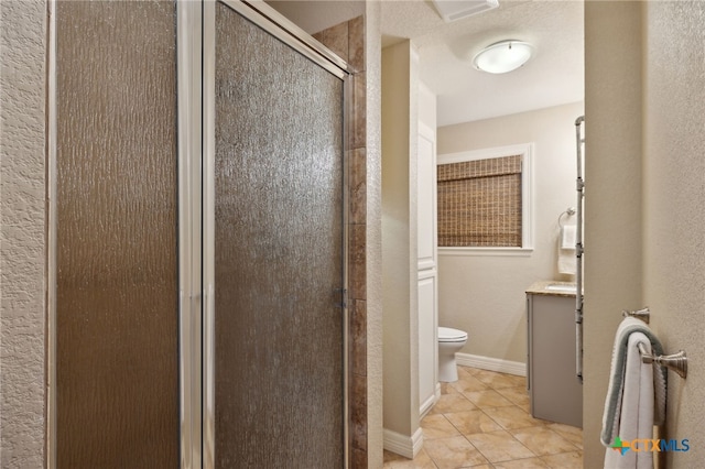 95 Mission Dr, New Braunfels, TX 78130 - bathroom with toilet, vanity, a stall shower, tile patterned flooring, and baseboards