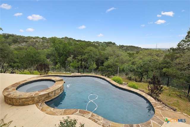 95 Mission Dr, New Braunfels, TX 78130 - view of swimming pool with a pool with connected hot tub, a forest view, and fence