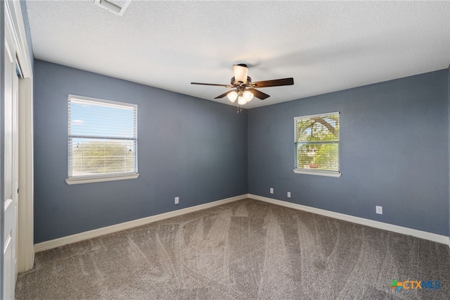 95 Mission Dr, New Braunfels, TX 78130 - spare room featuring baseboards, carpet floors, a ceiling fan, and visible vents