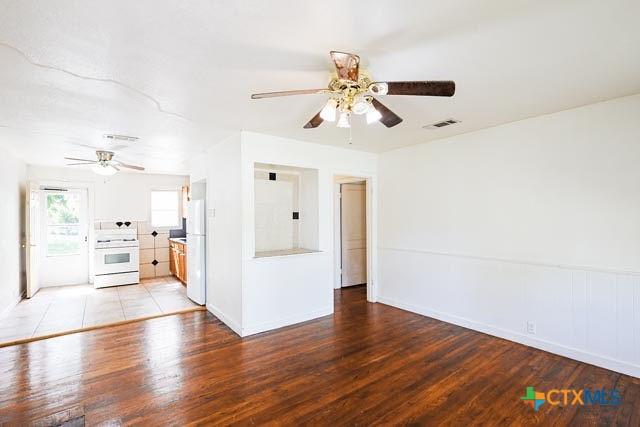 1707 S 43rd St, Temple, TX 76504 - unfurnished living room featuring ceiling fan, light wood finished floors, and baseboards