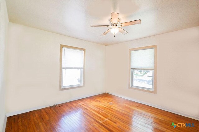 1707 S 43rd St, Temple, TX 76504 - spare room featuring healthy amount of natural light, wood finished floors, and ceiling fan