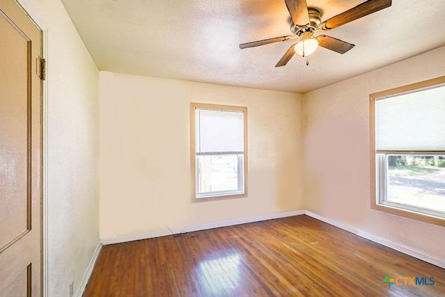 1707 S 43rd St, Temple, TX 76504 - empty room featuring healthy amount of natural light, wood finished floors, baseboards, and ceiling fan