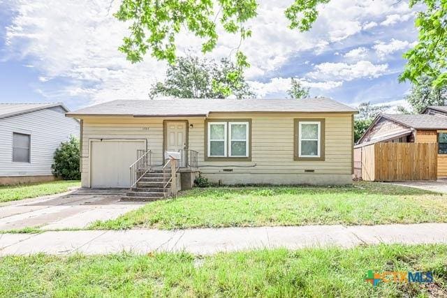 1707 S 43rd St, Temple, TX 76504 - view of front of home with an attached garage, concrete driveway, and crawl space