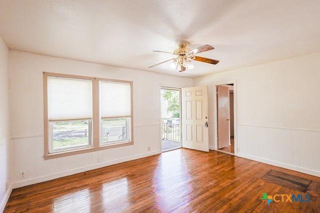1707 S 43rd St, Temple, TX 76504 - unfurnished room with ceiling fan, wood finished floors, and baseboards