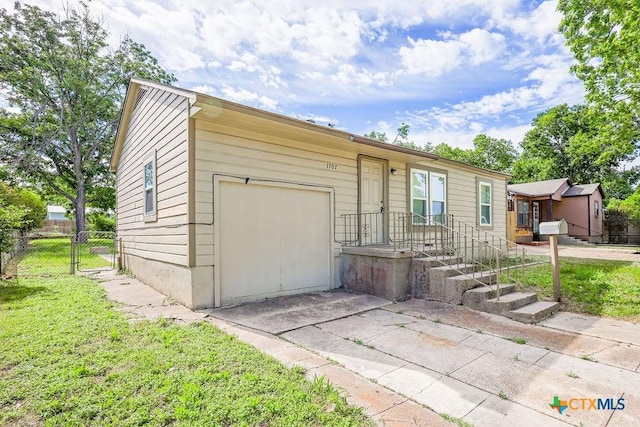1707 S 43rd St, Temple, TX 76504 - view of front of house with an attached garage, concrete driveway, and a gate