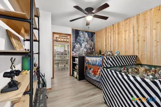 2305 Canyon Creek Dr, Temple, TX 76502 - bedroom with light wood-style flooring and wood walls