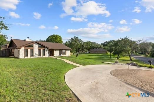 2305 Canyon Creek Dr, Temple, TX 76502 - view of community featuring a yard and curved driveway