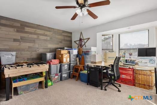 2305 Canyon Creek Dr, Temple, TX 76502 - carpeted home office with a ceiling fan and wood walls