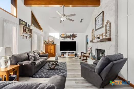2305 Canyon Creek Dr, Temple, TX 76502 - living area with high vaulted ceiling, ceiling fan, beam ceiling, a large fireplace, and light wood finished floors