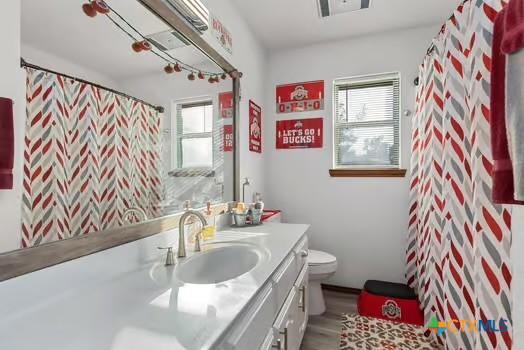 2305 Canyon Creek Dr, Temple, TX 76502 - full bathroom featuring toilet, vanity, and wood finished floors