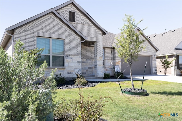 view of front of property with a garage and a front yard